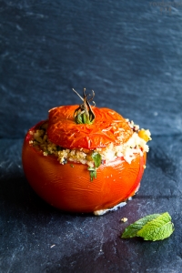 Stuffed tomatoes with couscous, chickpea, olives and tahini sauce